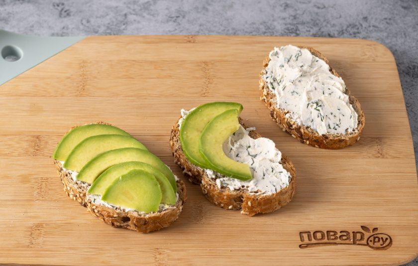 1. Этап. Быстрые бутерброды с авокадо: Сверху выложите ломтики авокадо. Приправьте черным молотым перцем.