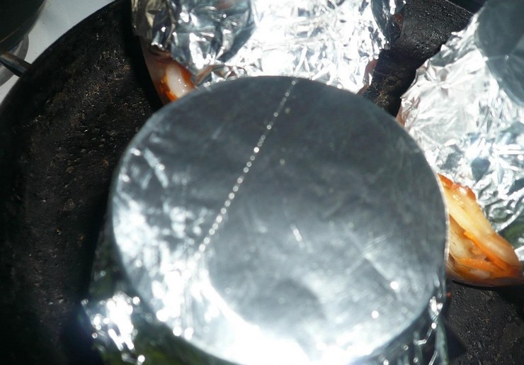 1. Этап. Кальмары с луком: Закройте банки фольгой. Отправьте их в духовой шкаф на полтора часа на самом слабом огне.