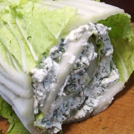 1. Stage. Cabbage curd roll: Disassemble the cabbage into leaves so as not to damage them. Grease each leaf with the cooked filling and fold the cabbage back leaf by leaf.