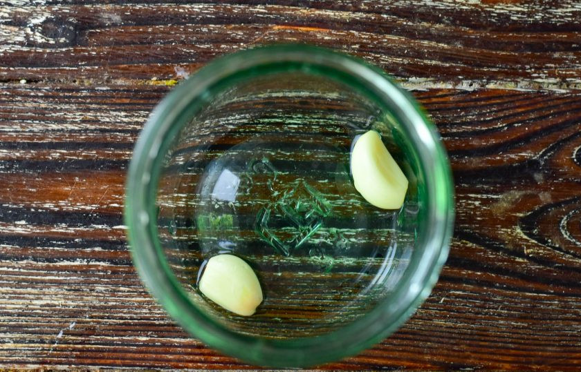 1. Этап. Кисло-сладкие маринованные огурцы: На дно чистой банки выложите дольки чеснока, которые предварительно очистите.