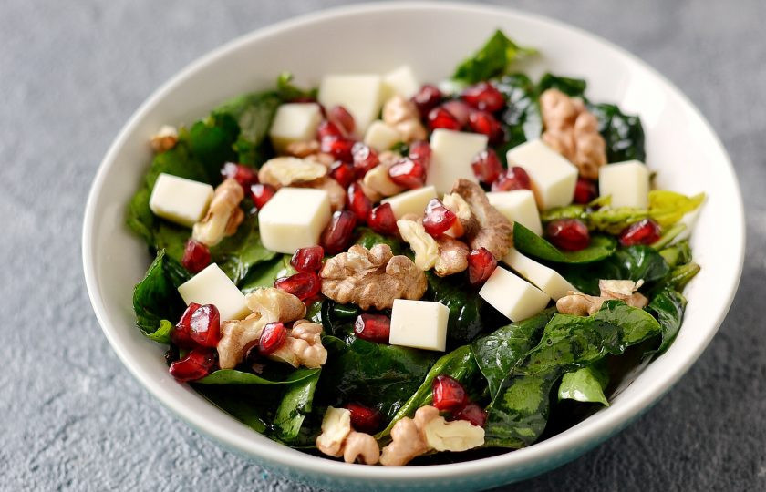 1. Этап. Салат со шпинатом, орехами и гранатом: Выложите сверху грецкие орехи, зерна граната и сыр.
