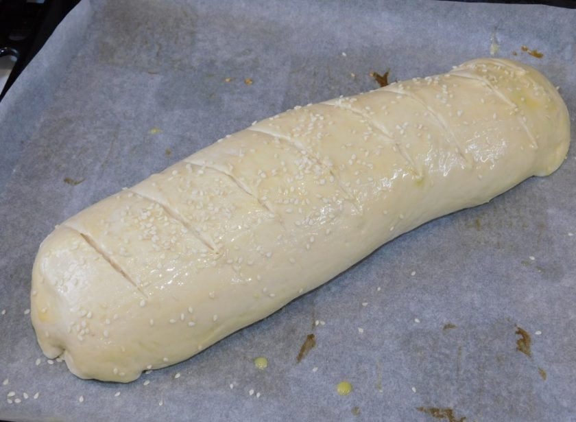 1. Этап. Белый хлеб с сыром и орехами: Скатайте в рулет, подверните бока. Смажьте верх желтком и посыпьте кунжутом. Поставьте запекаться в духовку, разогретую до 200 градусов, минут на 30-40.