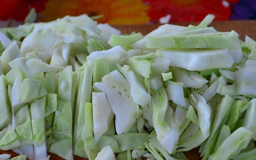 1. Этап. Борщ в казане на костре: Казан с водой (примерно 4,5 литра) поставьте на огонь и доведите до кипения. Капусту и ботву помойте и нарежьте соломкой.