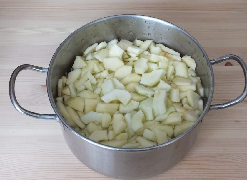 1. Этап. Яблочный джем с апельсинами: Нарежьте очищенные яблоки на четвертинки. Чтобы плоды не потемнели, в кастрюлю налейте воду и добавьте соль (соотношение на 1 литр воды 10 грамм соли). В этом растворе яблоки хорошо сохраняют цвет.