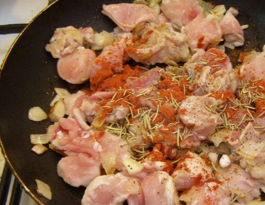 1. Этап. Гуляш из кролика с подливкой: Добавляем к мясу паприку и сухие травы. Перемешиваем и жарим до легкого золотистого цвета.