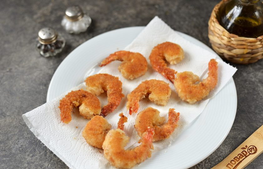 1. Этап. Креветки в панировке на сковороде: Выложите обжаренные креветки на бумажное полотенце, чтобы убрать лишнее масло.