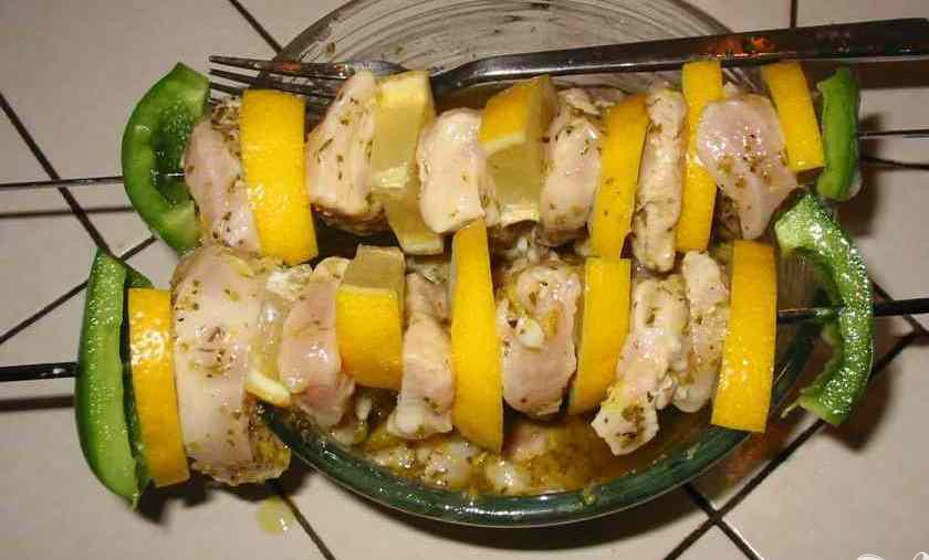 1. Этап. Куриные шашлыки с лимоном: 2. Гриль поставить на максимум. Разрезать перец на две части, удалить серединку и семена и разрезать его на восемь кусков. Нарезать два оставшихся лимона кружочками и разрезать каждый из кружочков на четвертинки. Наколоть на шампур перец, лимон и курицу.
