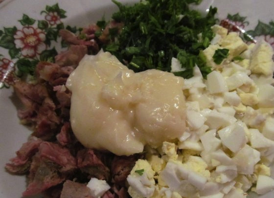 1. Этап. Салат мясной со свининой: Для начала нам нужно поставить отвариваться свинину, яйца и картофель. Яйца отварите вкурутую, а свинину и картофель - до мягкости. Тем временем нарубите зелень. А когда продукты сварятся, нарежьте всё небольшими кусочкми. Добавьте майонез.