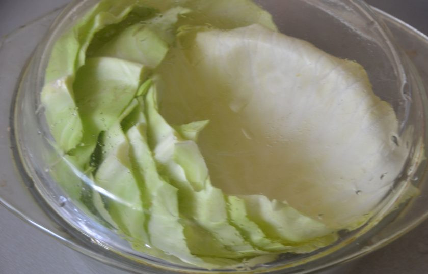 1. Этап. Голубцы по-цыгански: Сложите листья в закрытую посуду для СВЧ и поместите в микроволновую печь на 5 минут.