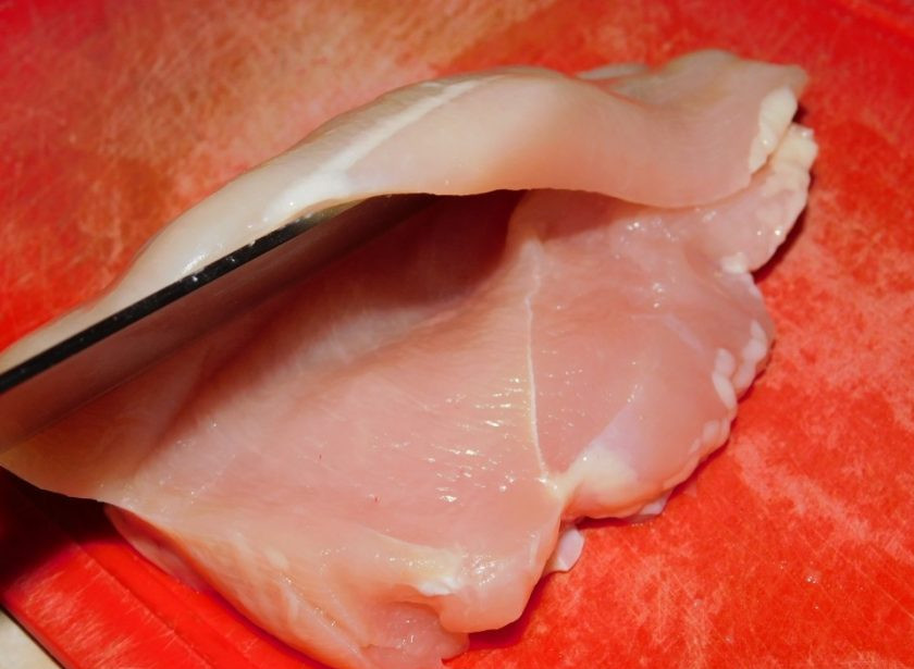 1. Этап. Запеченная куриная грудка с помидорами и чесноком: Каждую куриную грудку разрежьте вдоль, не доходя до конца. Тем самым, сделав небольшой кармашек.