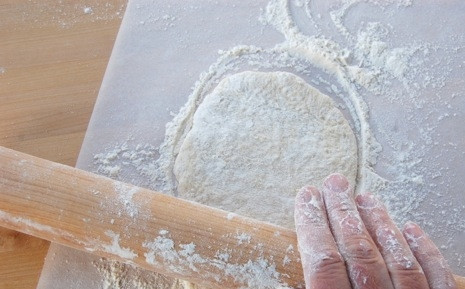 1. Этап. Армянский лаваш в духовке: Духовку включите на 250 градусов, пусть греется. Оторвите от теста небольшой кусочек и начните его раскатывать, присыпав мукой, на куске пергаментой бумаги.