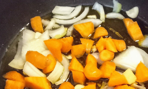 1. Этап. Эфиопский тикил гомен: В казане разогрейте масло и добавьте лук и морковь Готовьте, помешивая минут 5.