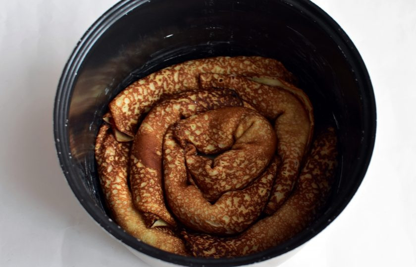 1. Этап. Блинный торт с шоколадной заливкой: Скручивайте блинчики в тугие рулеты и плотно укладывайте по спирали в хорошо смазанную сливочным маслом чашу мультиварки.