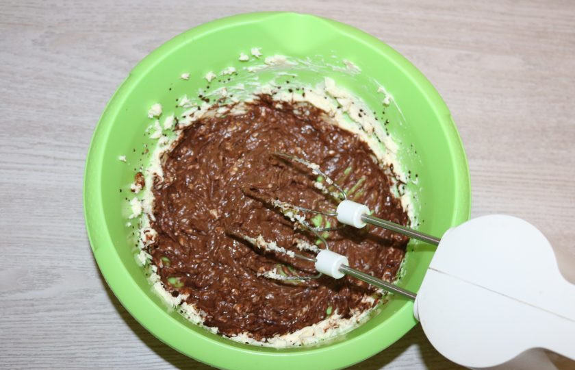 1. Этап. Торт «Причуда»: Отложите несколько ложек шоколадной массы для верха торта. Остальное постепенно добавляйте и взбивайте вместе с маслом.