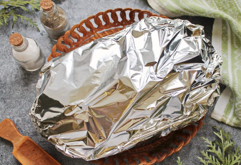 1. Этап. Гармошка из свинины с курагой, черносливом и сыром: Закройте форму фольгой для выпечки и поставьте в горячую духовку. Запекайте мясо при температуре 180 градусов в течение одного часа.