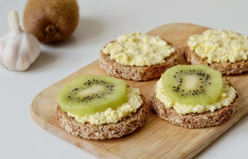 1. Этап. Канапе с киви: Выложите на ломтики хлеба сырную массу, сверху добавьте кружочки киви.