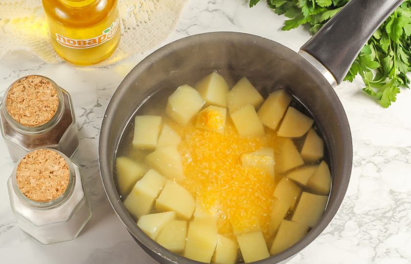 1. Этап. Кукурузный суп с фрикадельками: Промойте кукурузную крупу и всыпьте ее в емкость к картофелю.