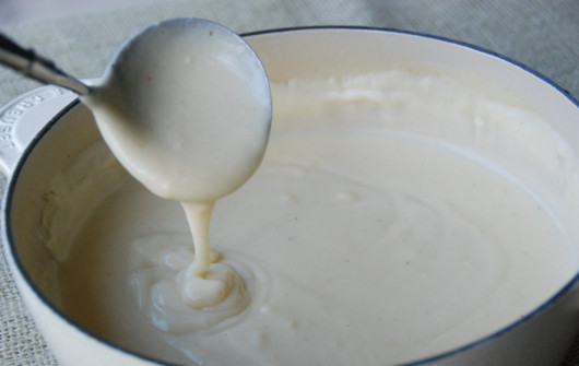 1. Этап. Курица в сырном соусе: 6. Сыр натереть на мелкой терке и ввести в соус. На медленном огне подержать еще около 2-3 минут, пока соус не станет однородным.