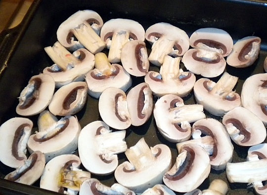 1. Этап. Мясо по-французски в духовке с грибами: 3. Вымытые и обсушенные грибочки нарежьте не очень тонкими пластинками и выложите на дно жаропрочной формы. Немного подсолите сверху.