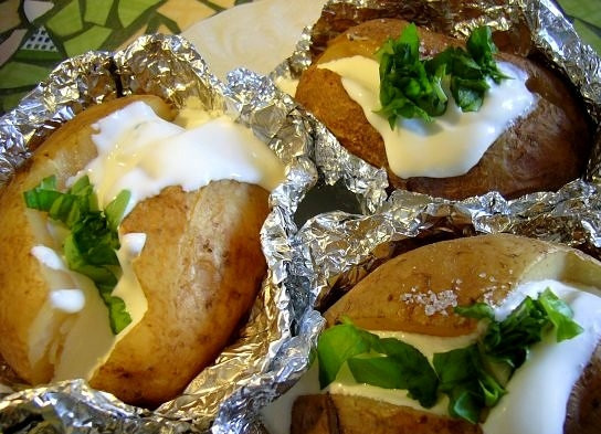 1. Этап. Картофель, запеченный в фольге: Отправить картофель в духовку еще на 5 минут, после чего подать к столу, разложив по порционным тарелкам. Едят такой картофель прямо из фольги (так он дольше остается теплым) маленькими ложечками. Приятного аппетита!