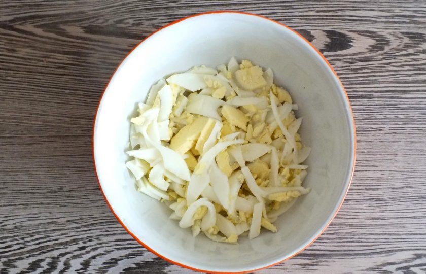 1. Этап. Салат с черешковым сельдереем и курицей: Яйца нарежьте соломкой и выложите в салатник.