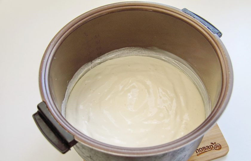 1. Этап. Бисквит для торта в мультиварке: Должно получиться пышное и нежное тесто. Смажьте чашу мультиварки сливочным маслом. Дно и бока хорошо присыпьте мукой. Если сомневаетесь в своей чаше, лучше застелите ее пергаментом. Переложите тесто в чашу и разровняйте.