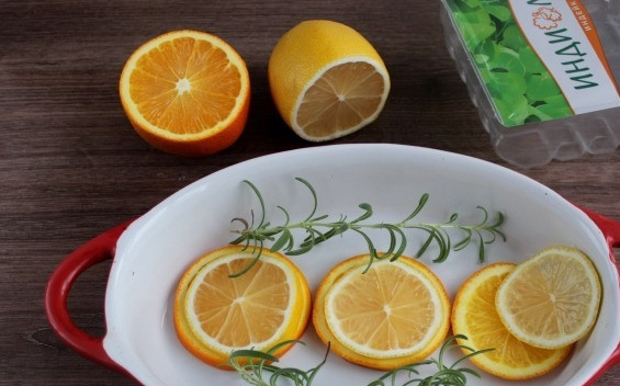 1. Этап. Филе грудки индейки в апельсиновом соусе: В форму для запекания выложите апельсиновые кружочки, на них лимонные и сверху уложите веточки розмарина.