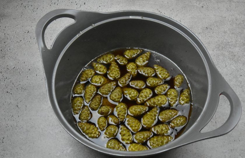 1. Этап. Сосновое варенье: Переложите отложенные шишки в сироп. Поставьте посуду с вареньем на огонь. Доведите до кипения, поварите 10 минут, периодически мешая. Снимите с огня и дайте полностью остыть. Таким образом повторите данный этап трижды. На последнем этапе варки, добавьте в варенье сок лимона.