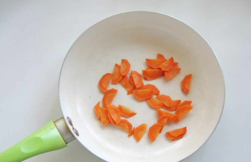 1. Этап. Куриное филе с шампиньонами в сметане: Одну небольшую морковку или половину крупной очистите, помойте и нарежьте. Выложите в сковороду.