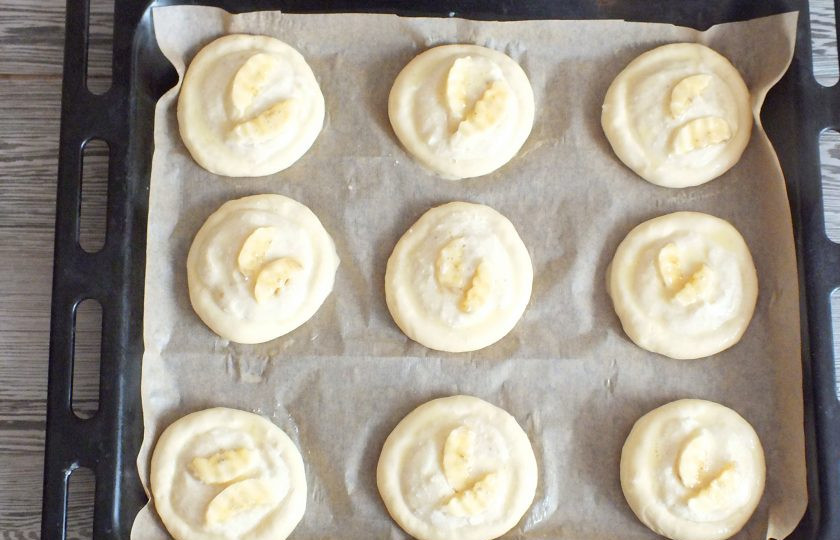 1. Этап. Ватрушки с бананом: Нарежьте банан на кусочки и разложите их на ватрушки. Смажьте взбитым яйцом. Поставьте выпекаться в разогретую до 180 градусов духовку на 15-20 минут.