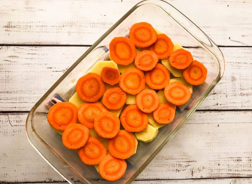 1. Этап. Печеный картофель со свеклой: Морковь очистите, нарежьте кружочками и выложите поверх картофеля.