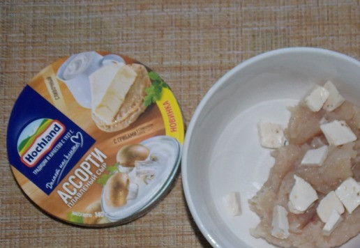 1. Этап. Фаршированные шампиньоны с фаршем и сыром: Добавить сыр (в треугольниках), нарезанный небольшими кусочками. Посолить по вкусу, перемешать.