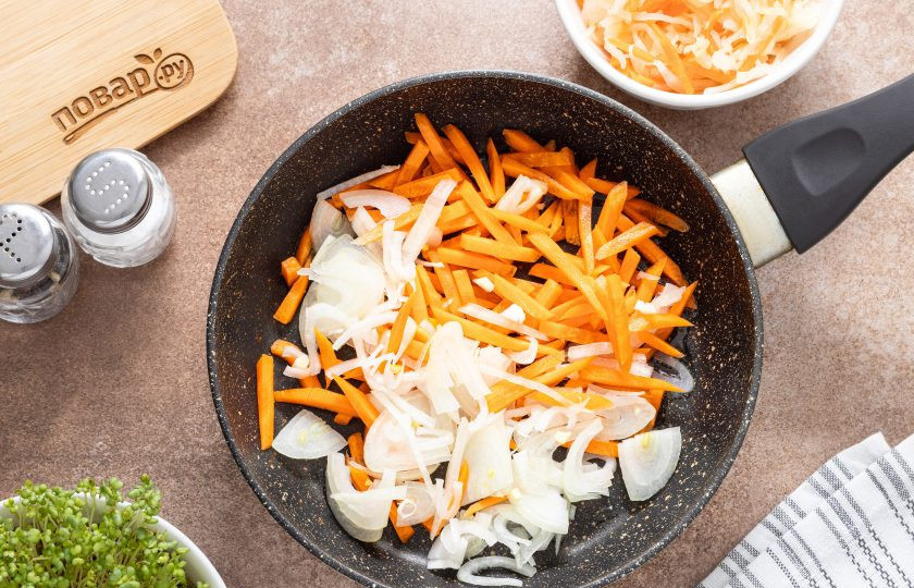 1. Этап. Щи из квашеной и свежей капусты: Параллельно очистите морковь и порежьте соломкой, а репчатый лук тонкими полукольцами. Разогрейте сковороду и обжарьте овощи с растительным маслом до золотистого цвета.