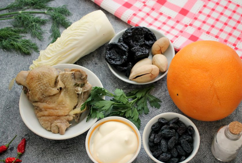 1. Этап. Салат с курицей в грейпфруте: Подготовьте все необходимые ингредиенты для приготовления салата с курицей в грейпфруте. Грейпфрут тщательно вымойте в горячей воде с мягкой щеточкой и обсушите. Чернослив и изюм замочите в горячей воде на 5-10 минут в зависимости от жесткости. Затем сухофрукты промойте и обсушите.