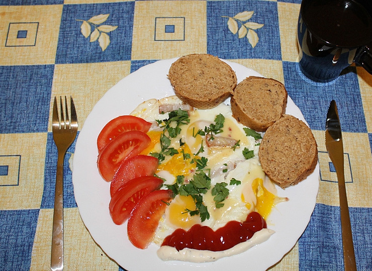 1. Этап. Завтрак чемпиона: 6. Нарежьте помидоры. На тарелку выложите яичницу. Посыпьте все зеленью. Рядом с ней выложите помидоры. Теперь, когда вы знаете, как приготовить завтрак чемпиона, порадуйте своих мужчин этим сытным завтраком. Приятного аппетита!