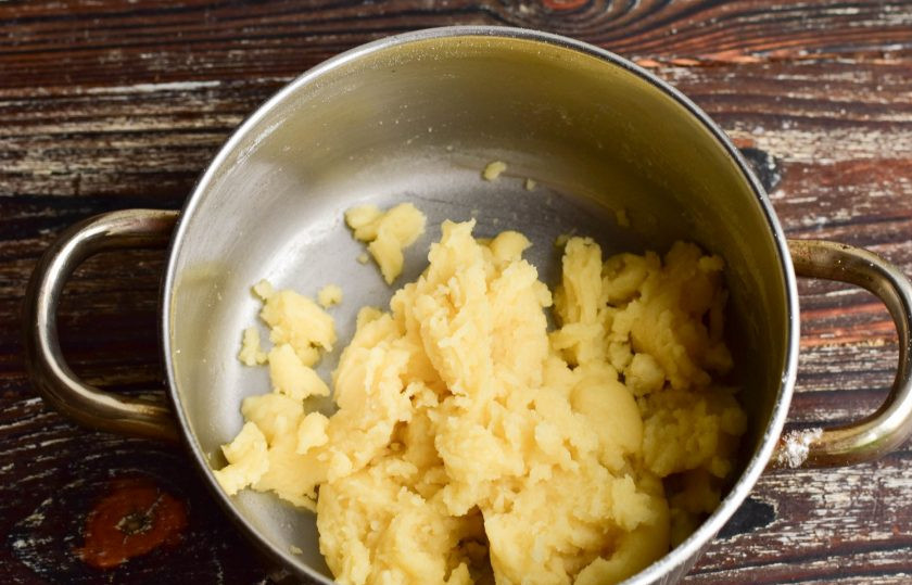 1. Этап. Профитроли с банановым кремом: Всыпьте муку. Заварите тесто до тех пор, пока оно не станет хорошо отставать от стенок кастрюли.