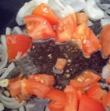 1. Этап. Тайский суп: Добавить мелко нарезанные чеснок и помидоры. Продолжать томить до мягкости помидоров.