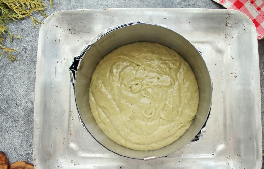 1. Этап. Бисквит с чаем матча: Разъемную форму поставьте на фольгу и поднимите края. Переложите тесто и разровняйте верх.