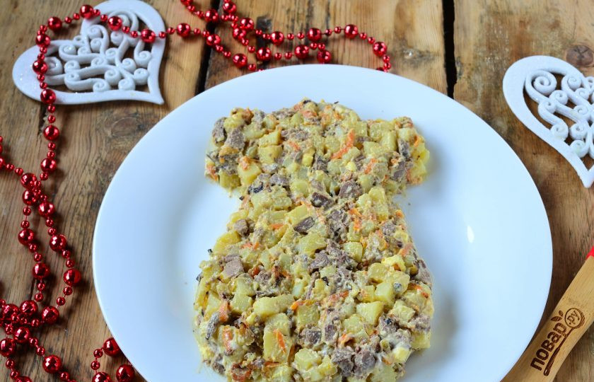 1. Этап. Новогодний салат в Год Собаки: Выложите салат на плоскую тарелку и придайте ему форму, как на фото.