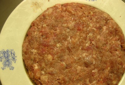 1. Этап. Зразы с яйцом в духовке: Мокрыми руками отрываем от фарша небольшой кусок и делаем из него лепешку.