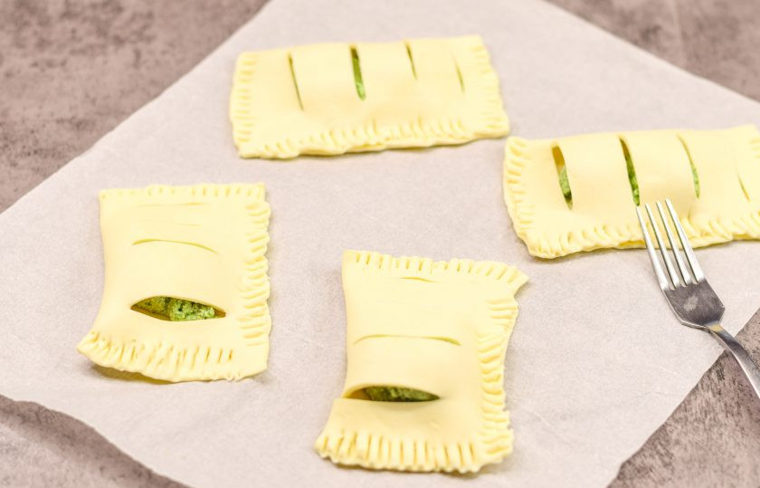 1. Этап. Слоеные пирожки с рикоттой и шпинатом: Прикройте начинку второй половиной теста, после края теста закрепите вилкой.