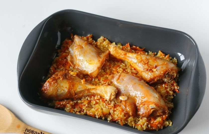 1. Этап. Курица на рисовой подушке: Форму смажьте маслом и выложите овощи с рисом. Сверху положите маринованную курочку.