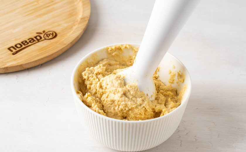 1. Этап. Бутерброды с хумусом: Измельчите нут вместе с оливковым маслом, кунжутной пастой, чесноком и лимонным соком до однородной, кремовой консистенции. Добавьте соль и молотый чёрный перец по вкусу и ещё раз пробейте блендером.