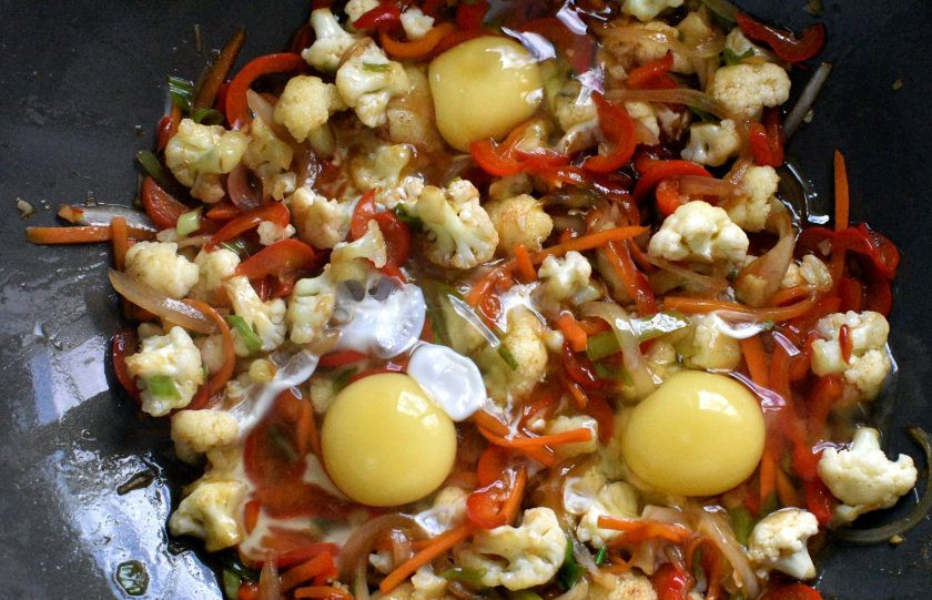 1. Этап. Цветная капуста с яйцами: Разбейте в овощи яйца.