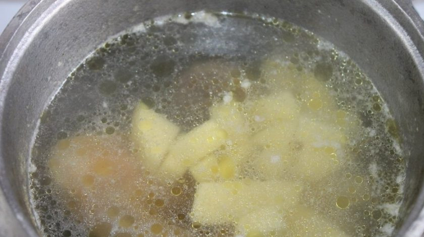 1. Этап. Суп со щавелем и крапивой: Где-то через час добавьте в бульон очищенный, промытый и нарезанный картофель.