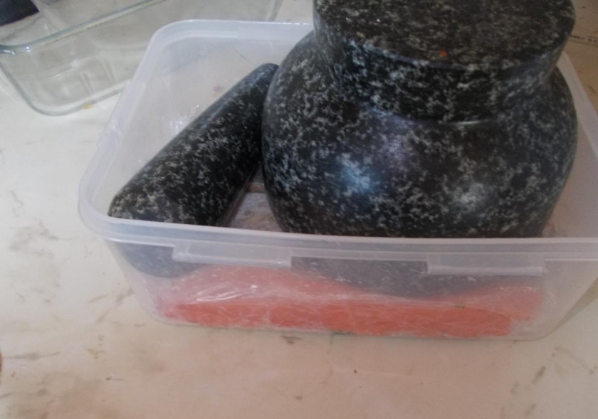 1. Этап. Лосось слабосоленый: 3. В пищевой пленке зубочисткой или вилкой делаем дырочки, а затем плотно заворачиваем в нее кусочки рыбы, укладываем их в глубокую форму. Сверху устанавливаем груз.