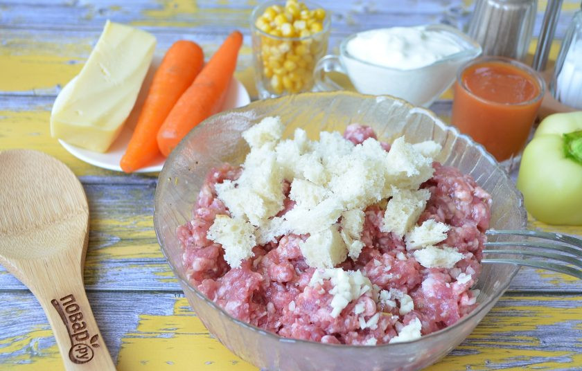 1. Этап. Мясные буханки с сюрпризом: 3. У хлеба срежьте грубую корочку, порвите мякоть руками и добавьте к фаршу, положите рубленный мелко чеснок, перемешайте хорошо вилочкой.