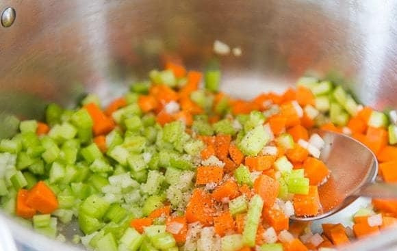 1. Этап. Нудл суп: 2. Далее в кастрюле разогрейте масло. Выложите в неё нарезанные овощи, соль и перец.