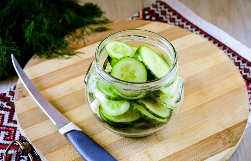 1. Этап. Салат из переросших огурцов на зиму без стерилизации: Выложите в банку колечки огурцов.