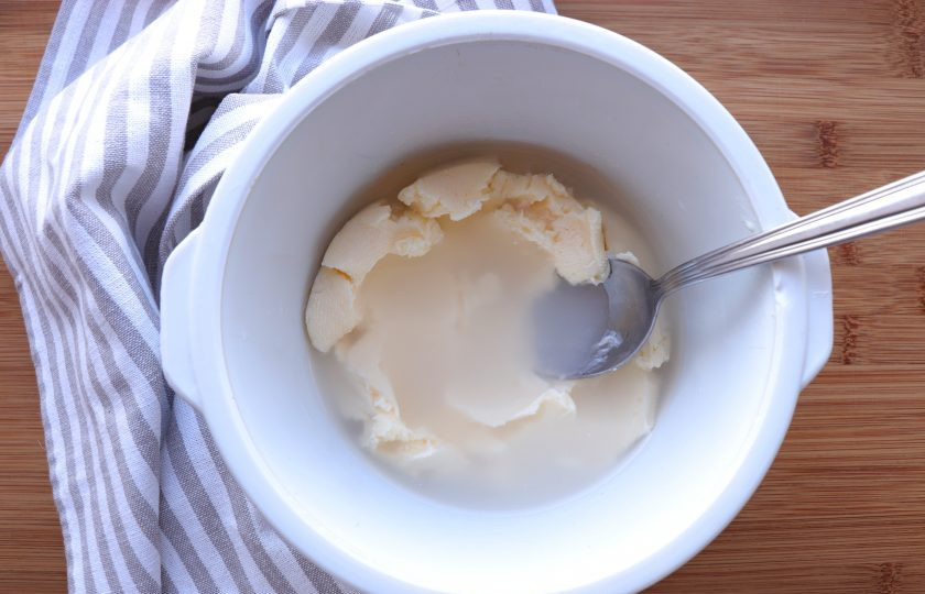 1. Этап. Домашнее масло из сметаны: Далее масло нужно промыть. Для этого переложите его в глубокую миску и залейте холодной кипяченой водой. При помощи ложки разминайте масло. Воду слейте и повторите процедуру еще два раза.